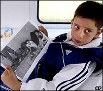 Georgy Farniyev with a picture of himself at the feet of the gunman