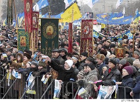 Supporters of Prime Minister Viktor Yanukovich wave blue ribons and various religious symbols during a rally in Donetsk